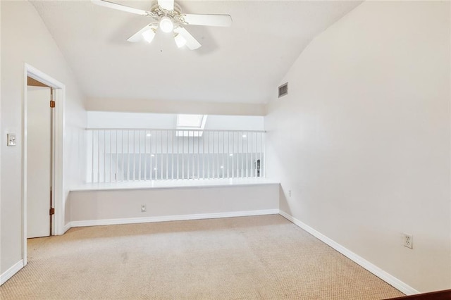 unfurnished room featuring ceiling fan, lofted ceiling, and light carpet