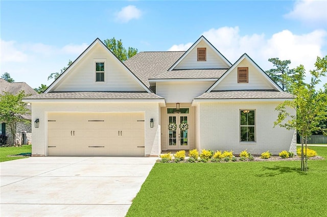 view of front of home with french doors, a front lawn, and a garage