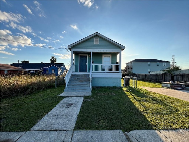 bungalow-style house with a porch and a front yard