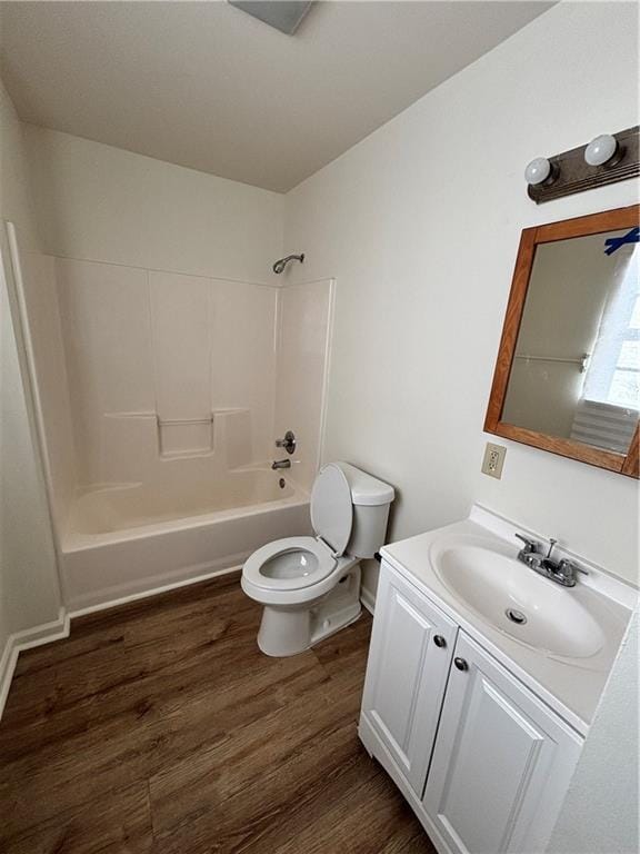 bathroom with shower / bathtub combination, vanity, toilet, and wood finished floors