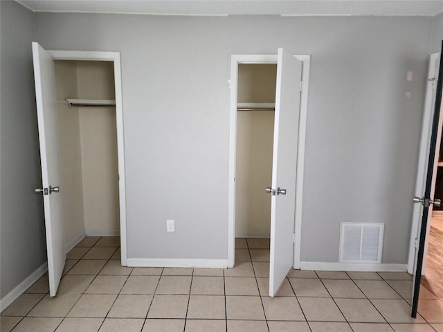 unfurnished bedroom featuring light tile patterned floors