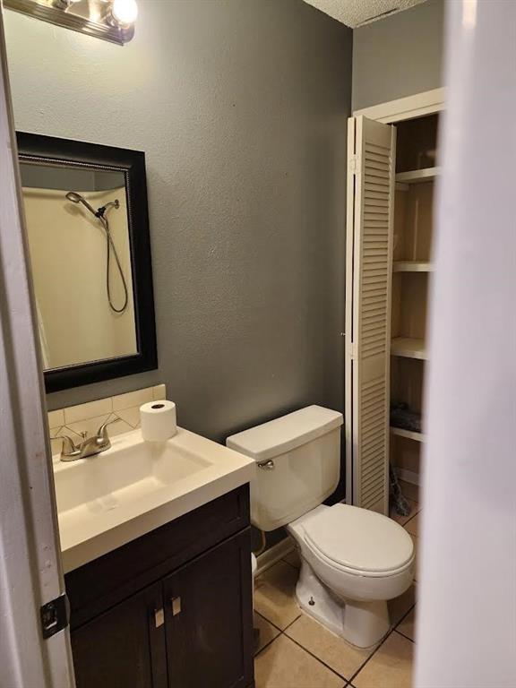 bathroom with tile patterned floors, vanity, and toilet