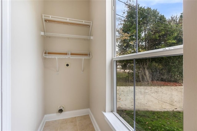 washroom with light tile patterned flooring and electric dryer hookup