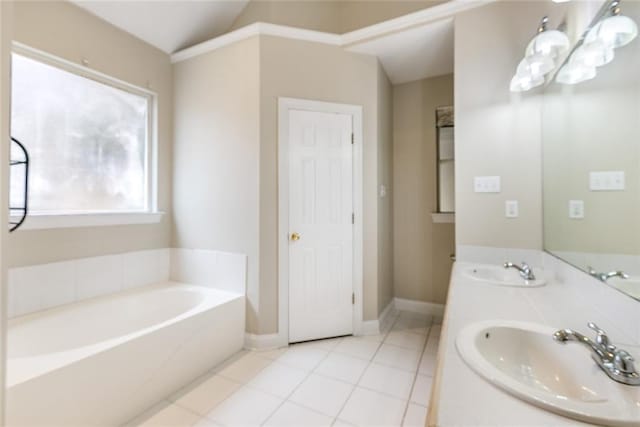 bathroom featuring vanity, lofted ceiling, tile patterned floors, and a bathtub