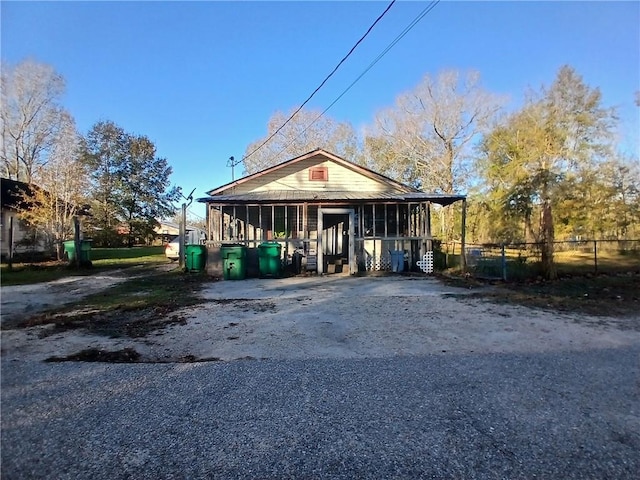 view of front of home featuring a sunroom