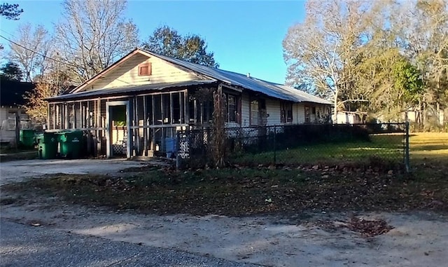 view of side of home with a sunroom