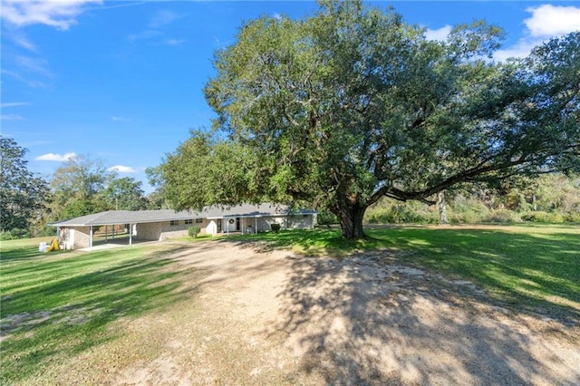 view of front of property with a carport and a front yard