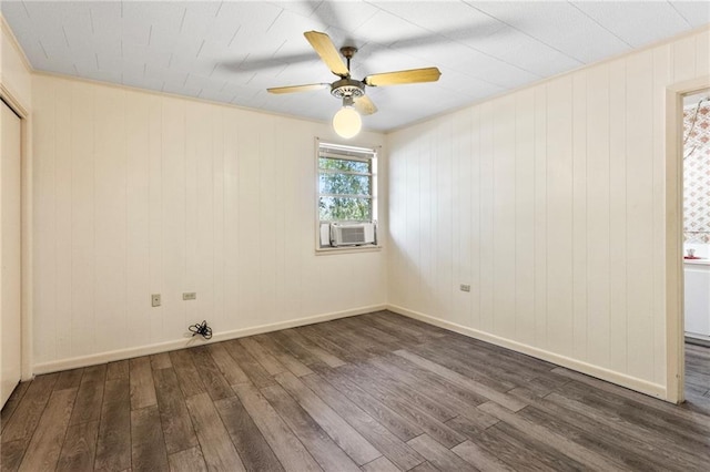 empty room with ceiling fan, cooling unit, and dark hardwood / wood-style floors