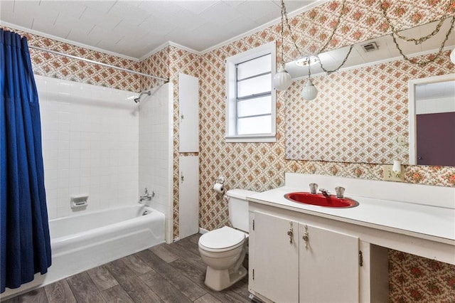 full bathroom with shower / tub combo, vanity, crown molding, hardwood / wood-style flooring, and toilet