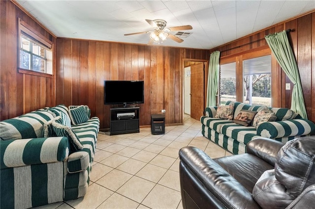 tiled living room featuring wooden walls and ceiling fan