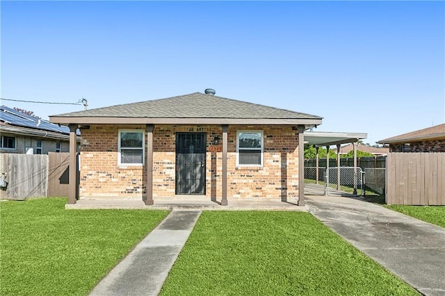 bungalow featuring a carport and a front yard