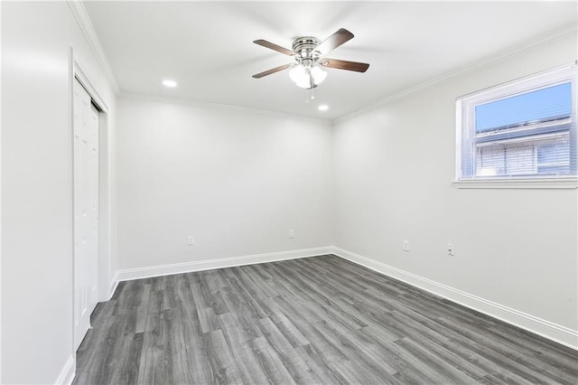 spare room with crown molding, ceiling fan, and dark hardwood / wood-style floors