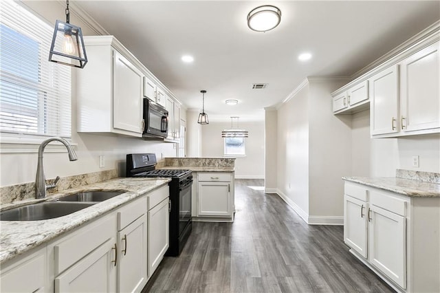 kitchen featuring sink, ornamental molding, black appliances, white cabinets, and decorative light fixtures