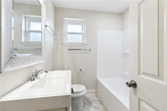 full bathroom featuring bathing tub / shower combination, a healthy amount of sunlight, sink, and toilet