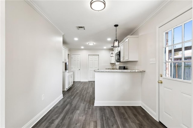 kitchen with dark wood-type flooring, white cabinetry, hanging light fixtures, ornamental molding, and light stone countertops