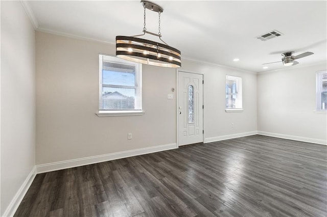 foyer with dark hardwood / wood-style flooring, crown molding, and ceiling fan