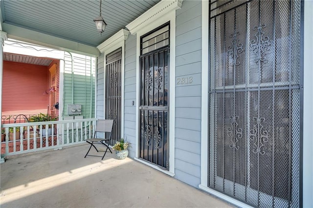 view of exterior entry with a porch