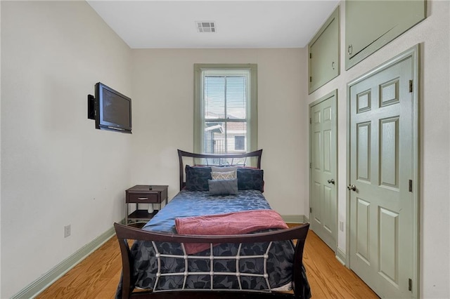 bedroom featuring light wood-type flooring and baseboards