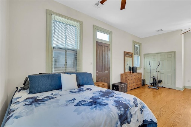 bedroom with ceiling fan, a closet, and wood-type flooring