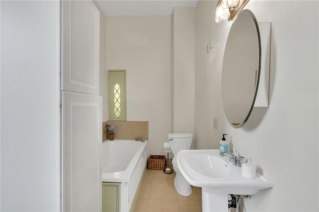 bathroom featuring tile patterned flooring, sink, toilet, and a washtub