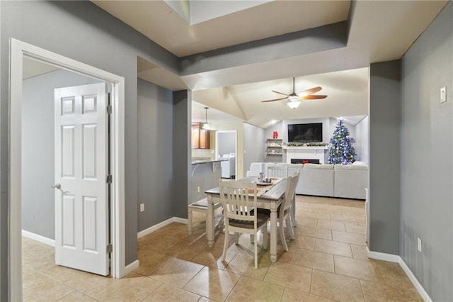 dining area with light tile patterned floors, vaulted ceiling, and ceiling fan