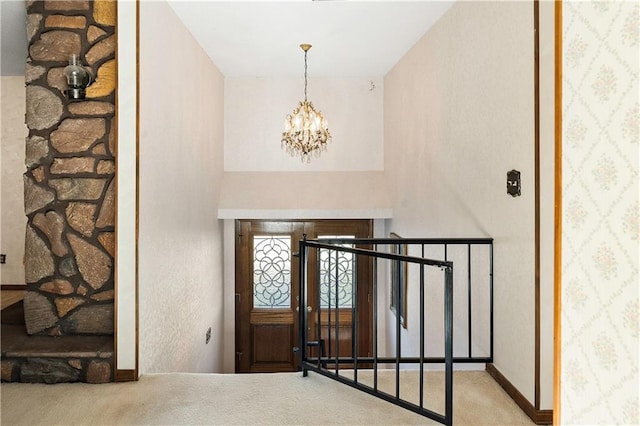 carpeted foyer featuring a notable chandelier