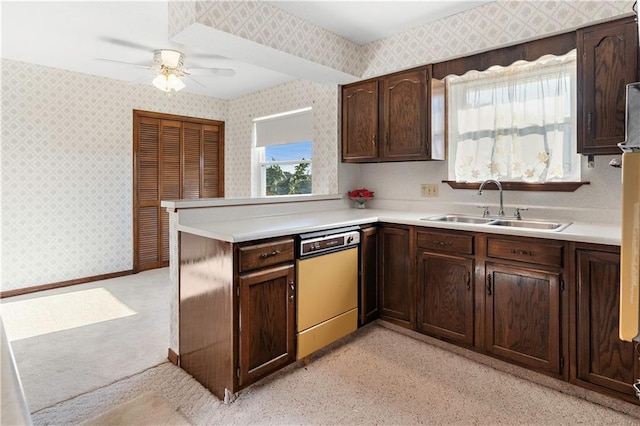 kitchen featuring kitchen peninsula, dishwashing machine, dark brown cabinets, ceiling fan, and sink