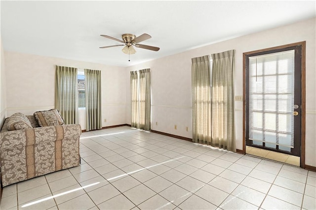 unfurnished living room featuring ceiling fan and light tile patterned flooring