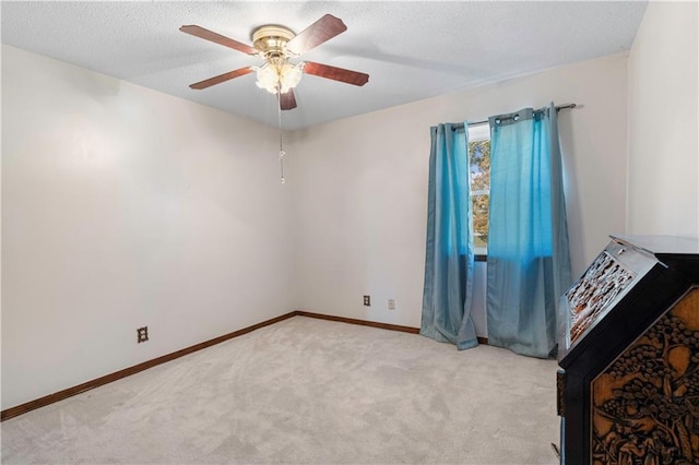 unfurnished bedroom with ceiling fan and light colored carpet