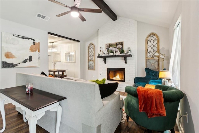 living room with a fireplace, dark hardwood / wood-style flooring, lofted ceiling with beams, and ceiling fan