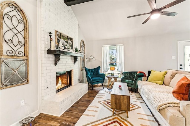 living room featuring a fireplace, dark hardwood / wood-style flooring, vaulted ceiling with beams, and ceiling fan