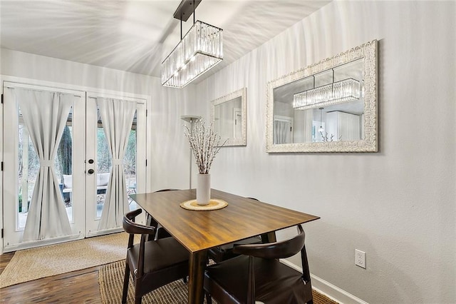 dining space with french doors and hardwood / wood-style flooring