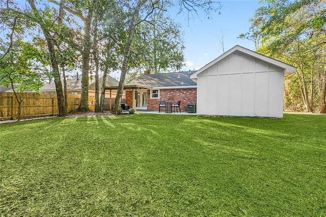 rear view of house featuring a lawn, cooling unit, and a patio