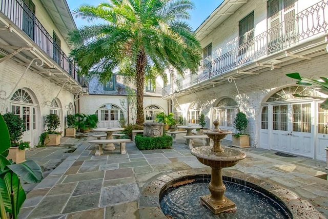 view of patio / terrace with french doors and a balcony