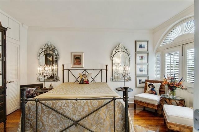 bedroom with wood-type flooring and crown molding