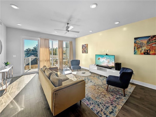 living room featuring dark hardwood / wood-style flooring and ceiling fan