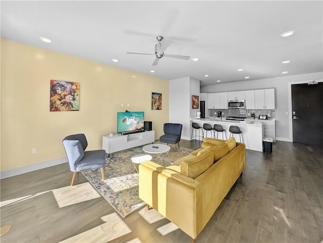 living room featuring ceiling fan and wood-type flooring