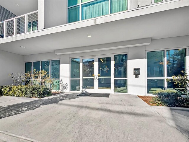 view of exterior entry featuring french doors