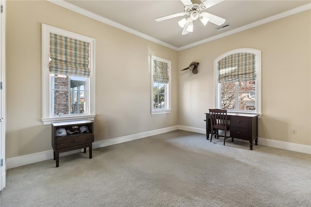 carpeted office featuring crown molding and ceiling fan