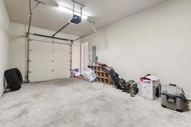 garage featuring electric panel and a garage door opener