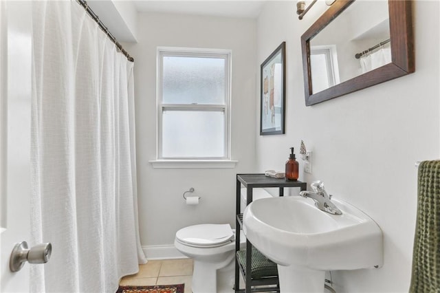 bathroom with tile patterned floors, sink, and toilet