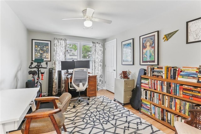 office area with light wood-type flooring and ceiling fan