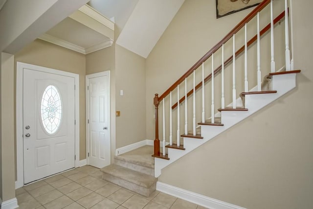 entrance foyer with light tile patterned floors and crown molding