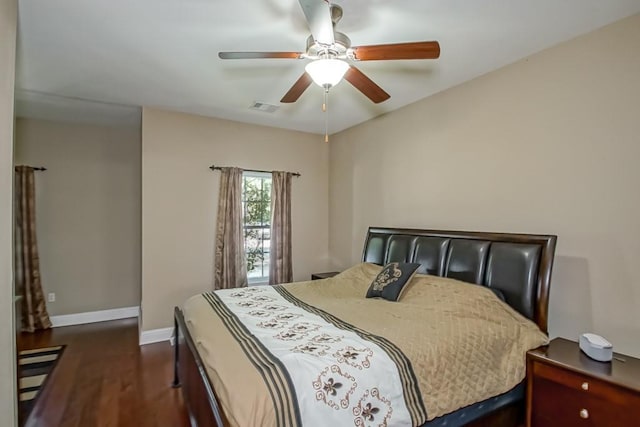 bedroom with dark hardwood / wood-style flooring and ceiling fan