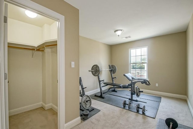 exercise room featuring light colored carpet