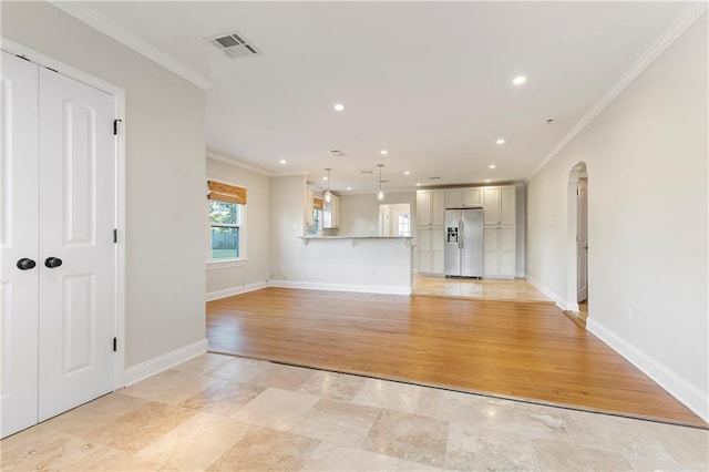 unfurnished living room with ornamental molding