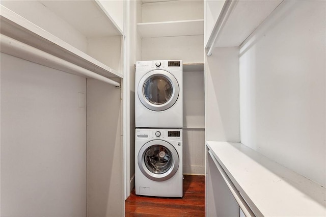 clothes washing area with laundry area, dark wood-type flooring, and stacked washer and dryer