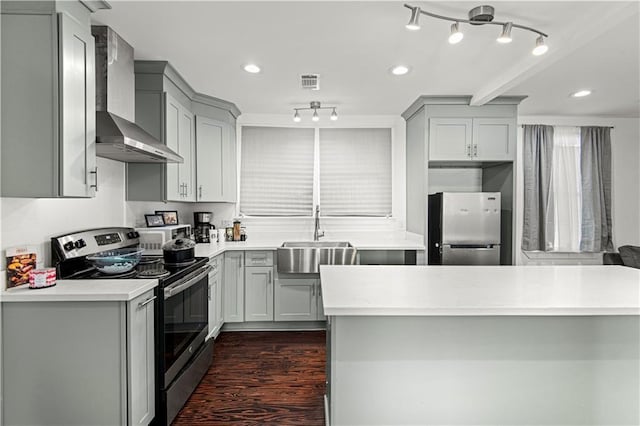 kitchen with sink, stainless steel appliances, gray cabinetry, and wall chimney range hood