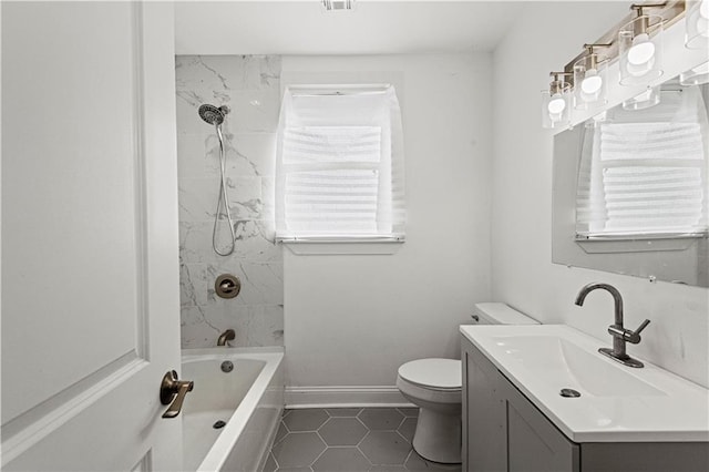 full bathroom featuring tiled shower / bath, tile patterned flooring, vanity, and toilet