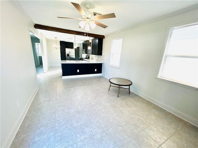 kitchen with stainless steel refrigerator with ice dispenser, a wealth of natural light, tasteful backsplash, beamed ceiling, and kitchen peninsula